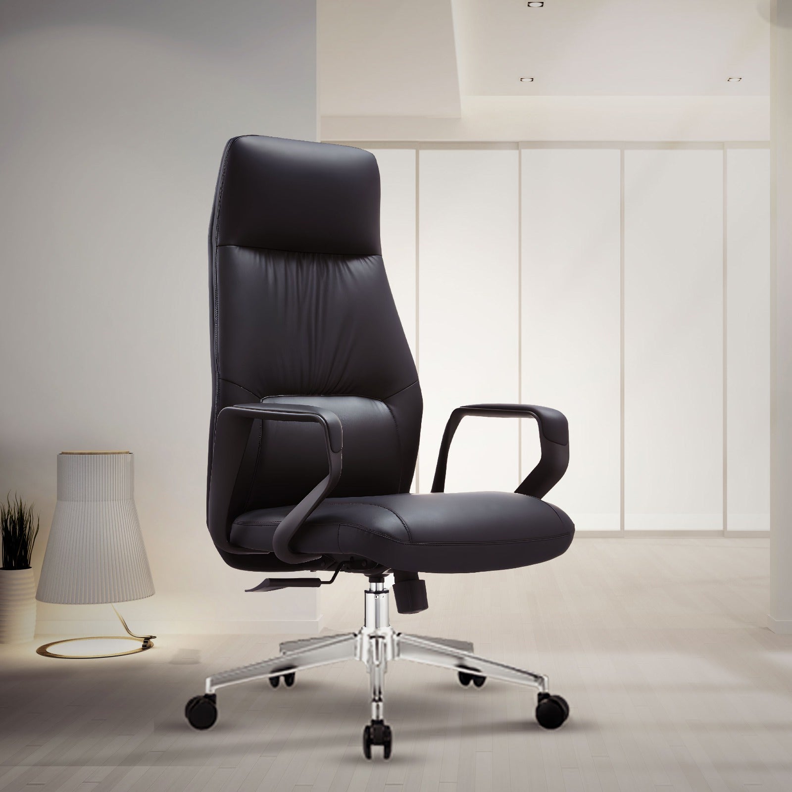 Black leather executive office chair with high back and chrome base, ergonomic design for comfort and support. Perfect for a modern office or home workspace in Bangladesh.